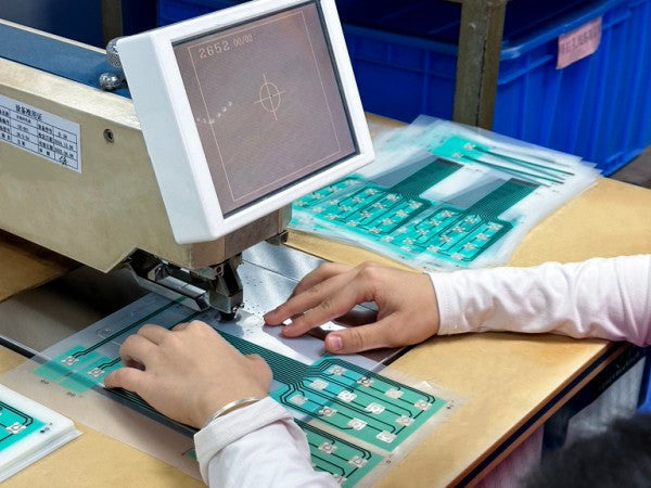 Stamping of positioning hole for membrane switch